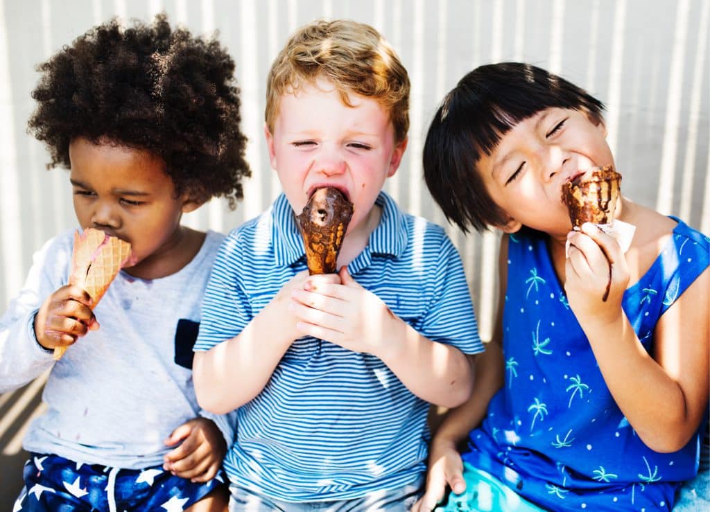 Kids eating ice cream in the summer.