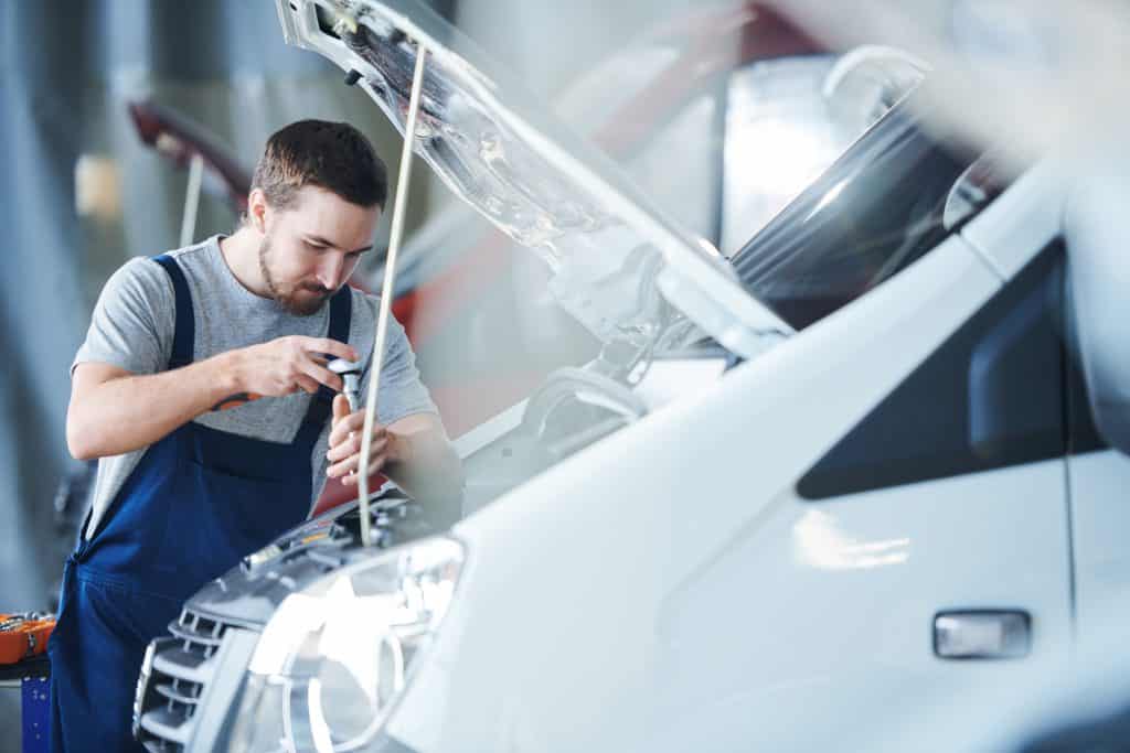 Mechanic installing new intercooler.